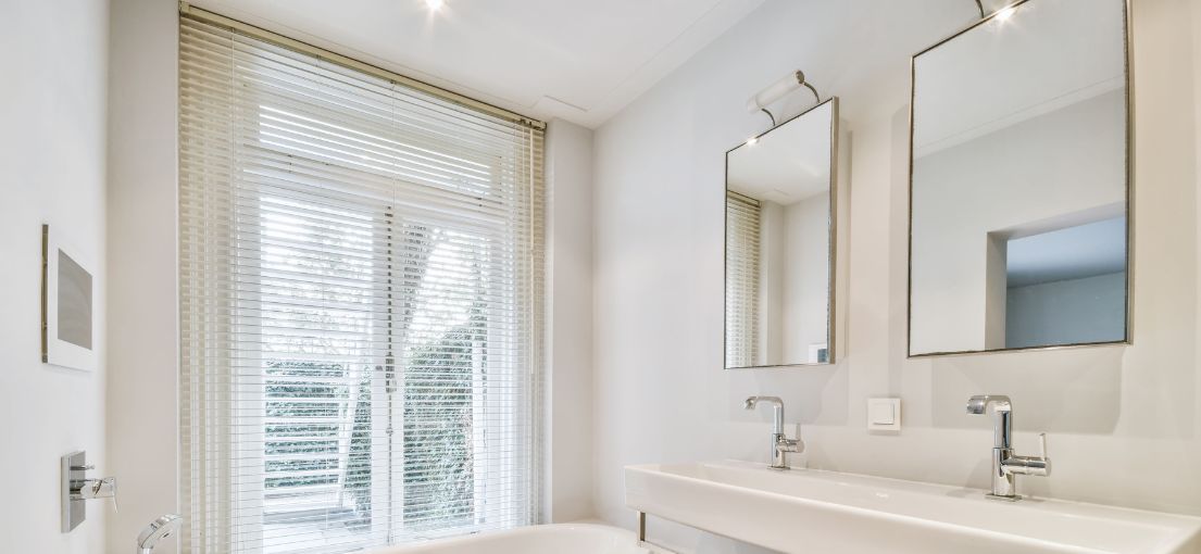 Luxurious bathroom with custom aluminum blinds in Malibu