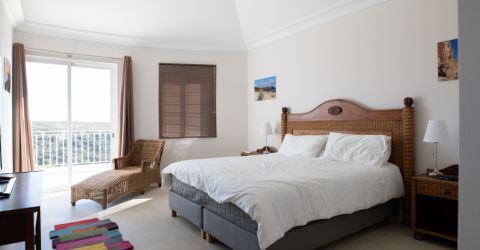 Warm and inviting bedroom with elegant brown Venetian blinds, creating a cozy atmosphere and adding a touch of sophistication to the space.