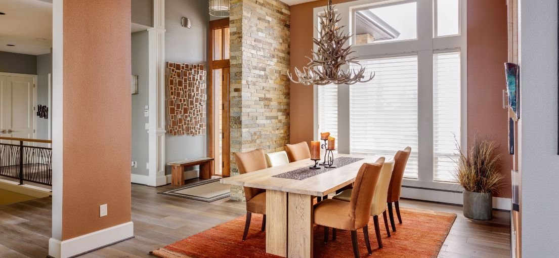 Elegant dining area with faux wooden blinds in West Hollywood home