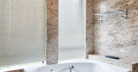 Elegant bathroom with granite tiles and mini blinds